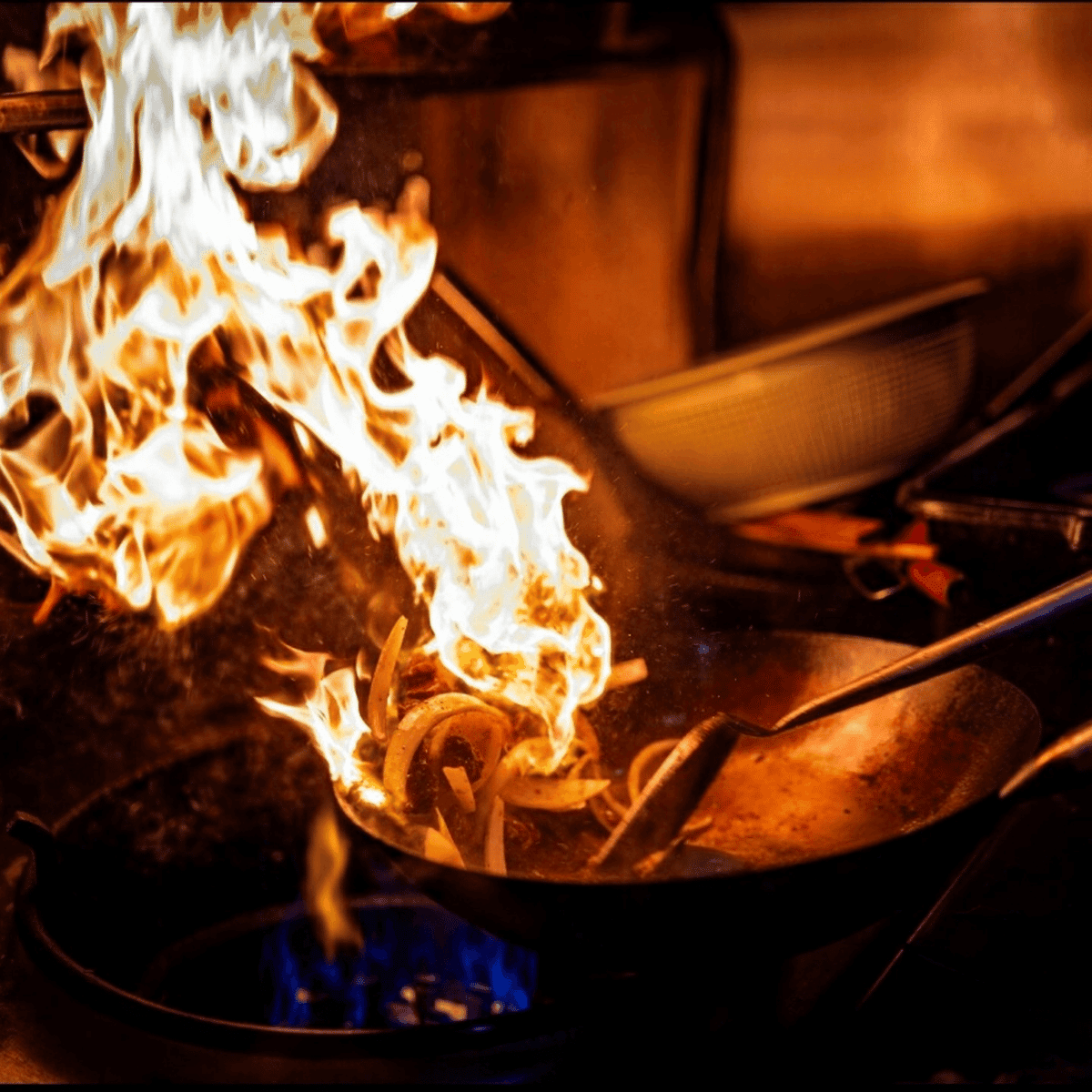 Flamed pan in kitchen of restaurant