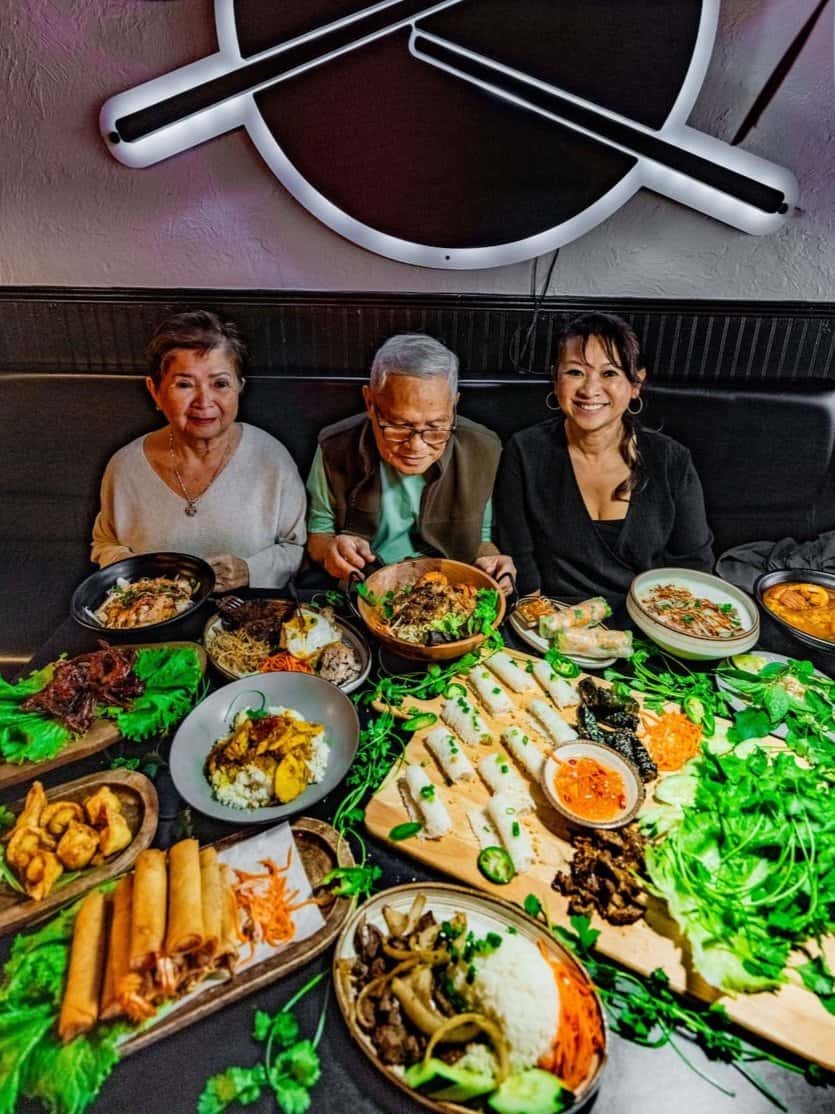 Owners of the restaurant surrounded by their food