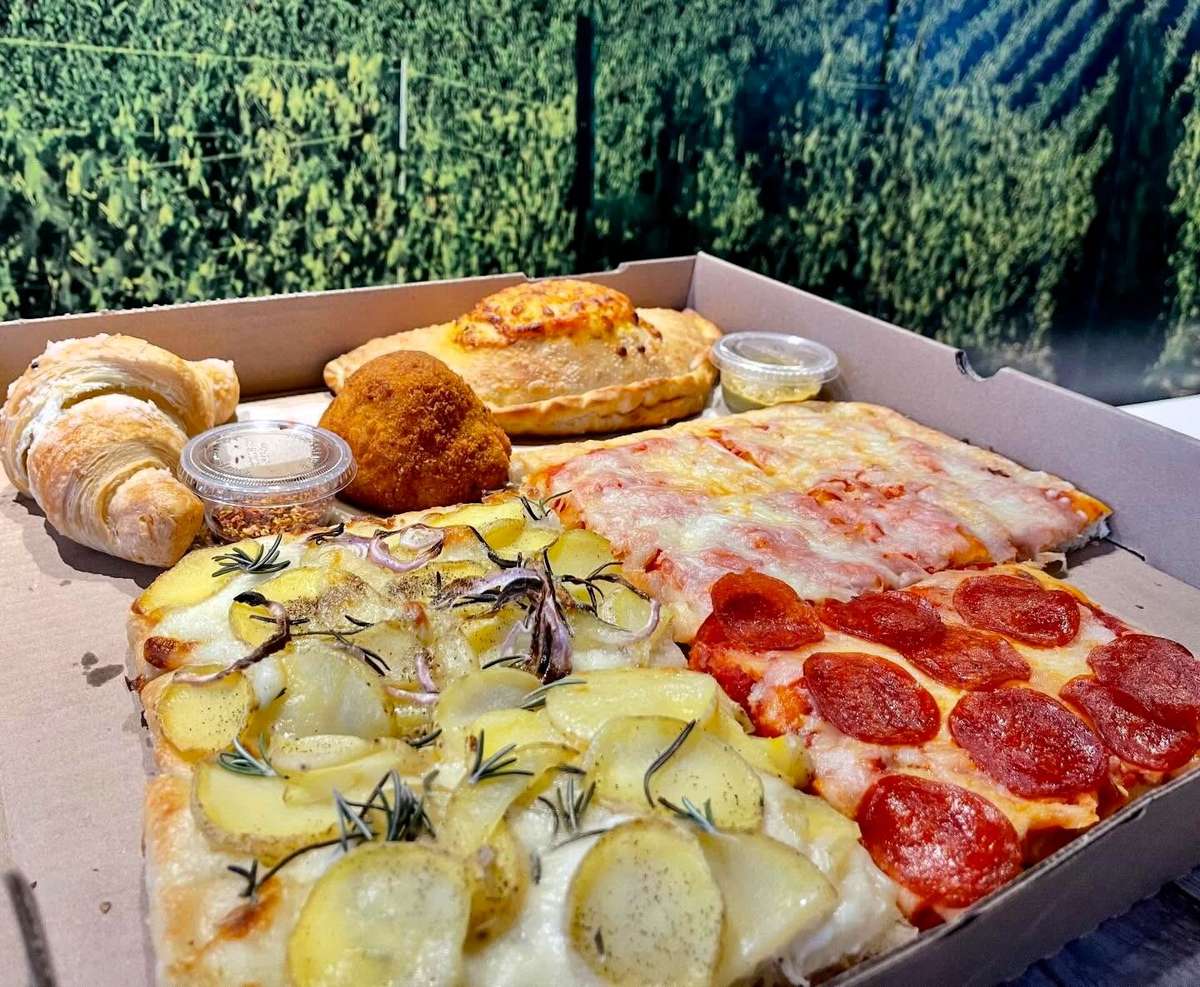 A box of different squares of pizza options