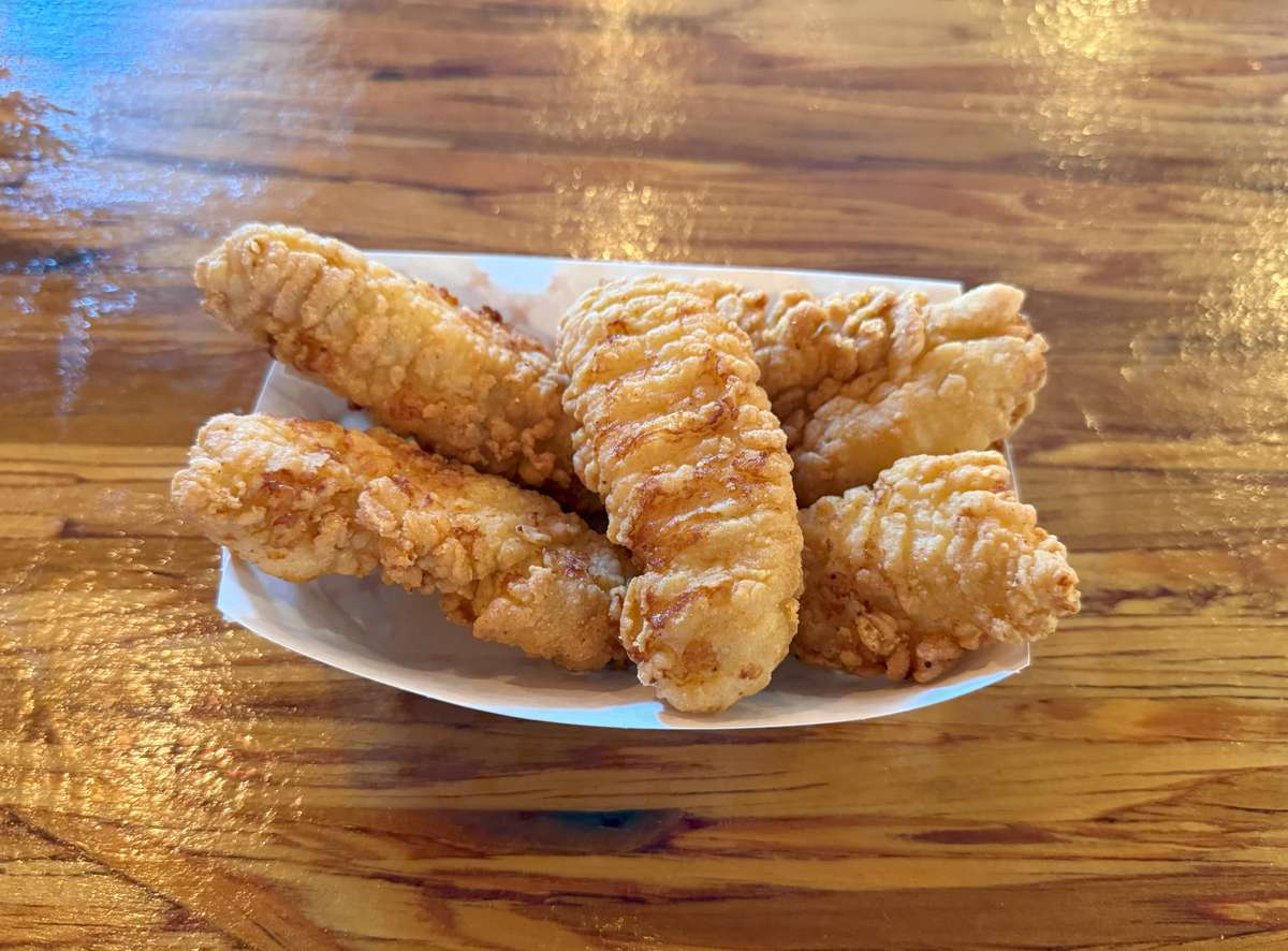 Golden fried chicken strips in a paper boat at Main Street Eats are ready to be served.