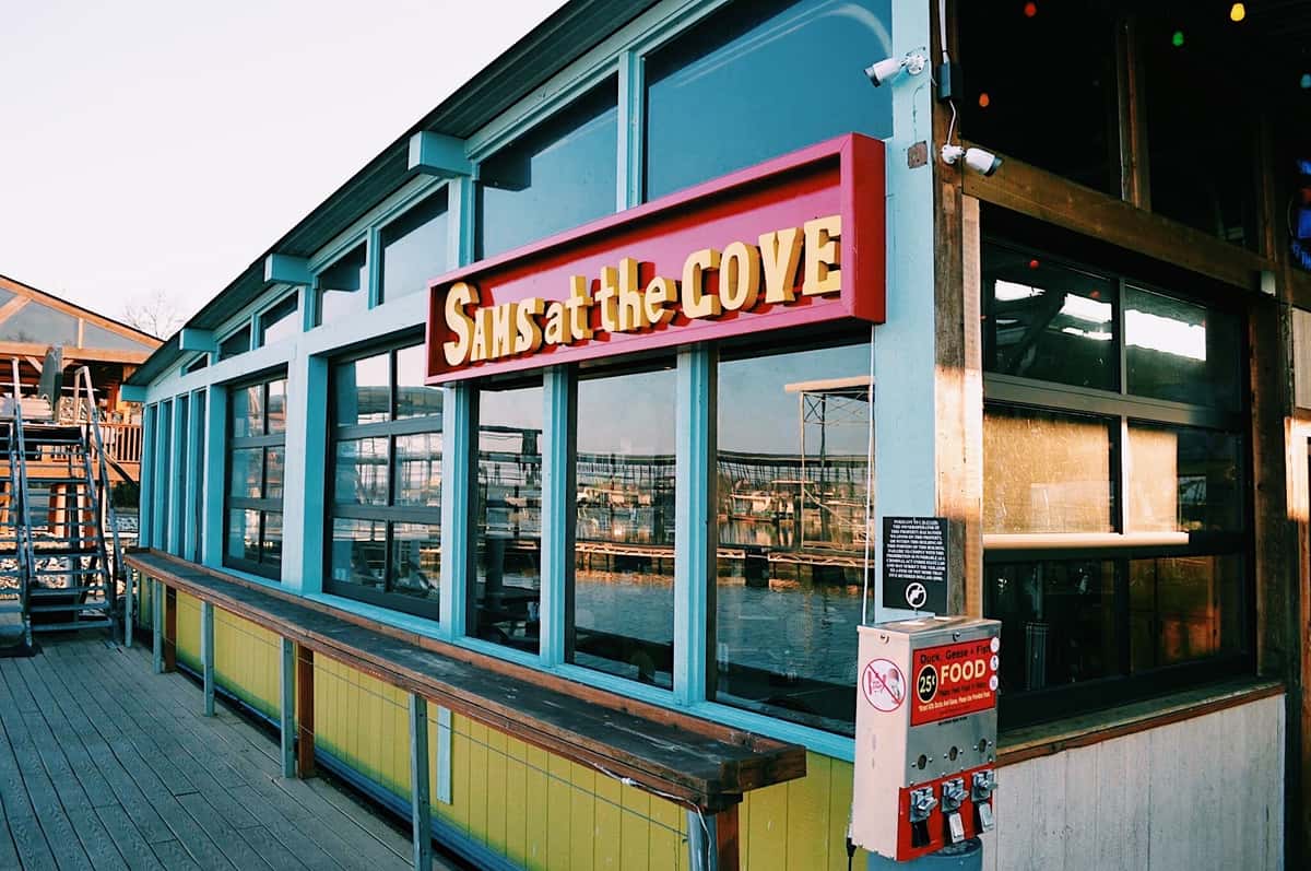 Exterior storefront of Sam's Place restaurant with signage