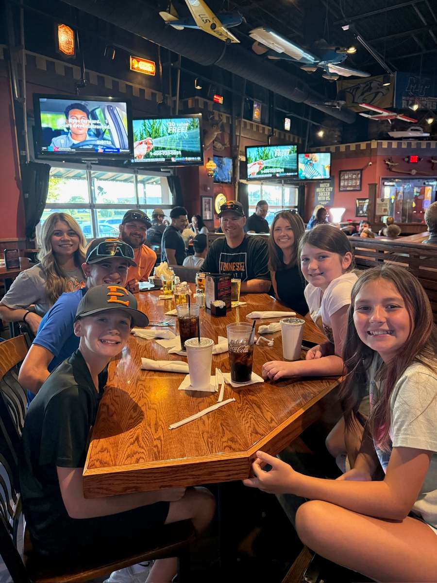 Group of guests seated at the bar enjoying drinks together