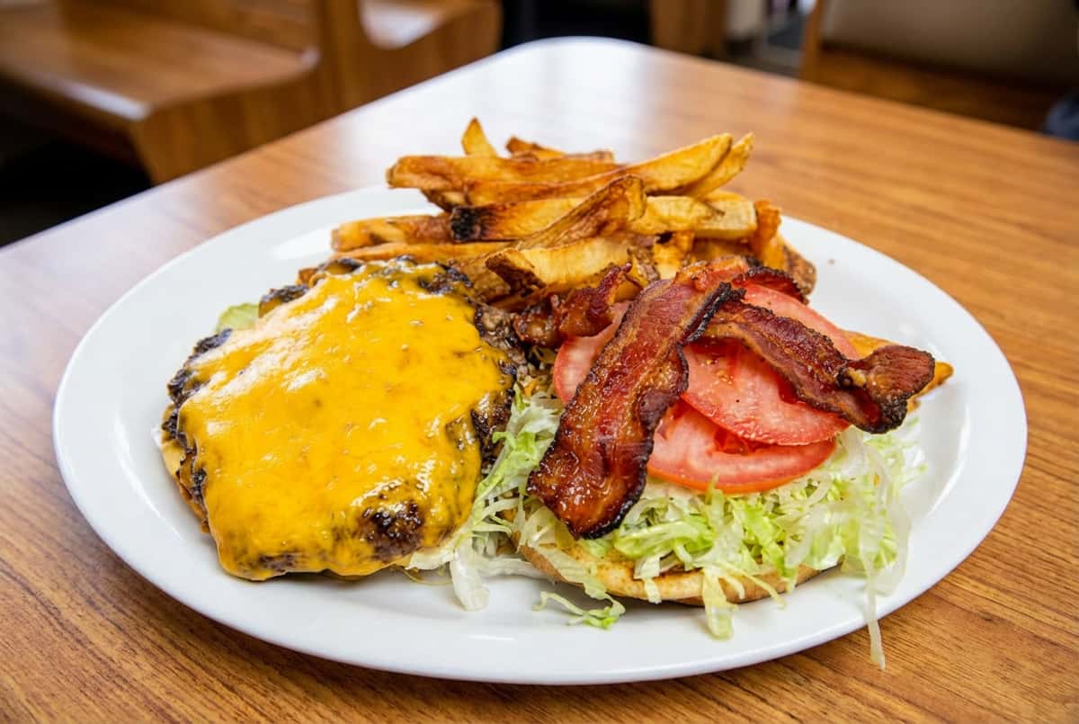 Burger and bacon with a side of fries
