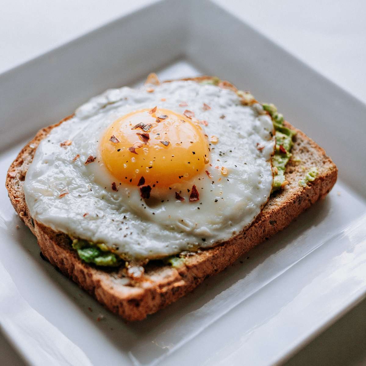 Sunnyside up egg on avocado toast