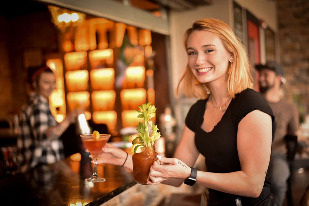 waitress holding bloody mary