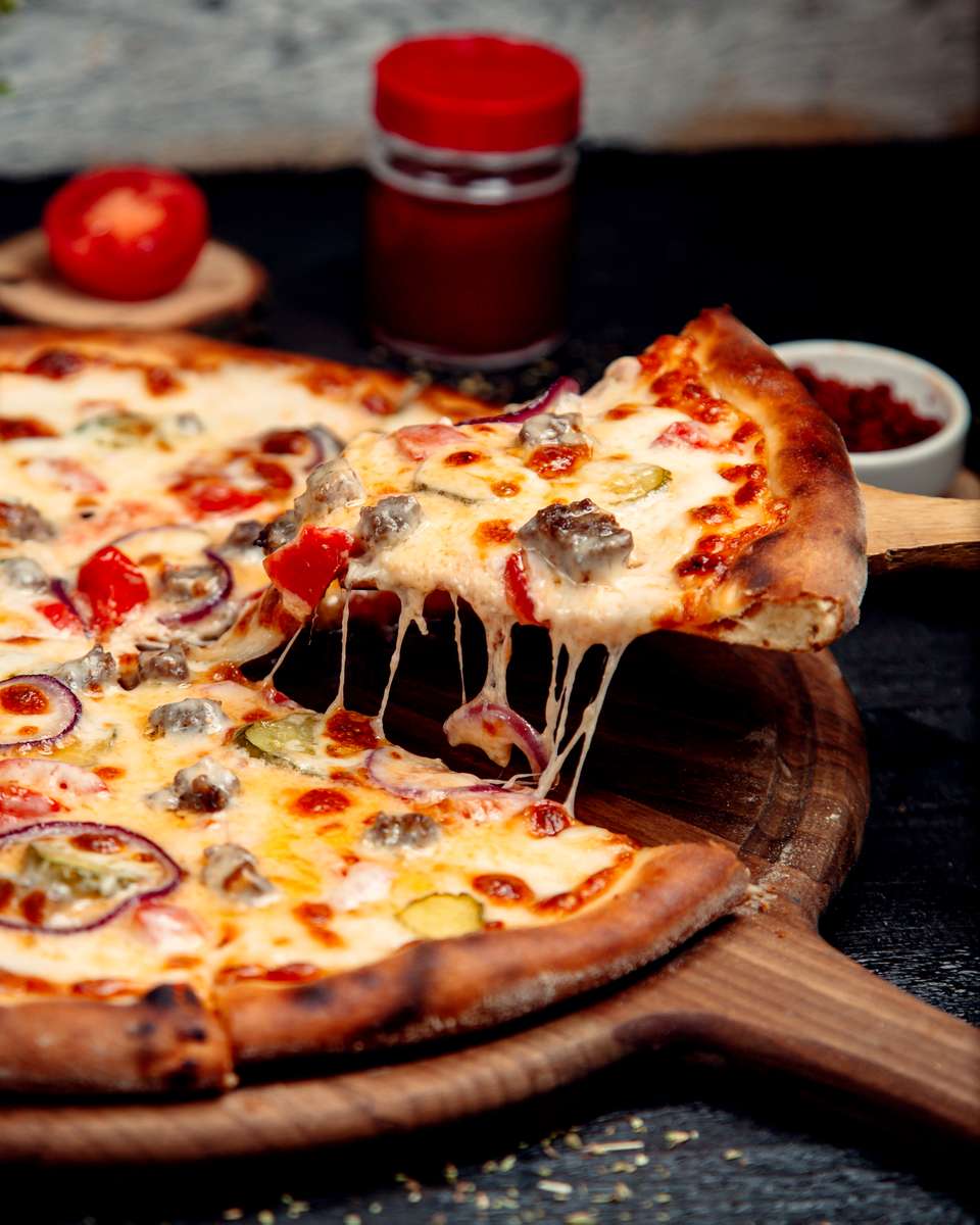 Pizza slice being lifted