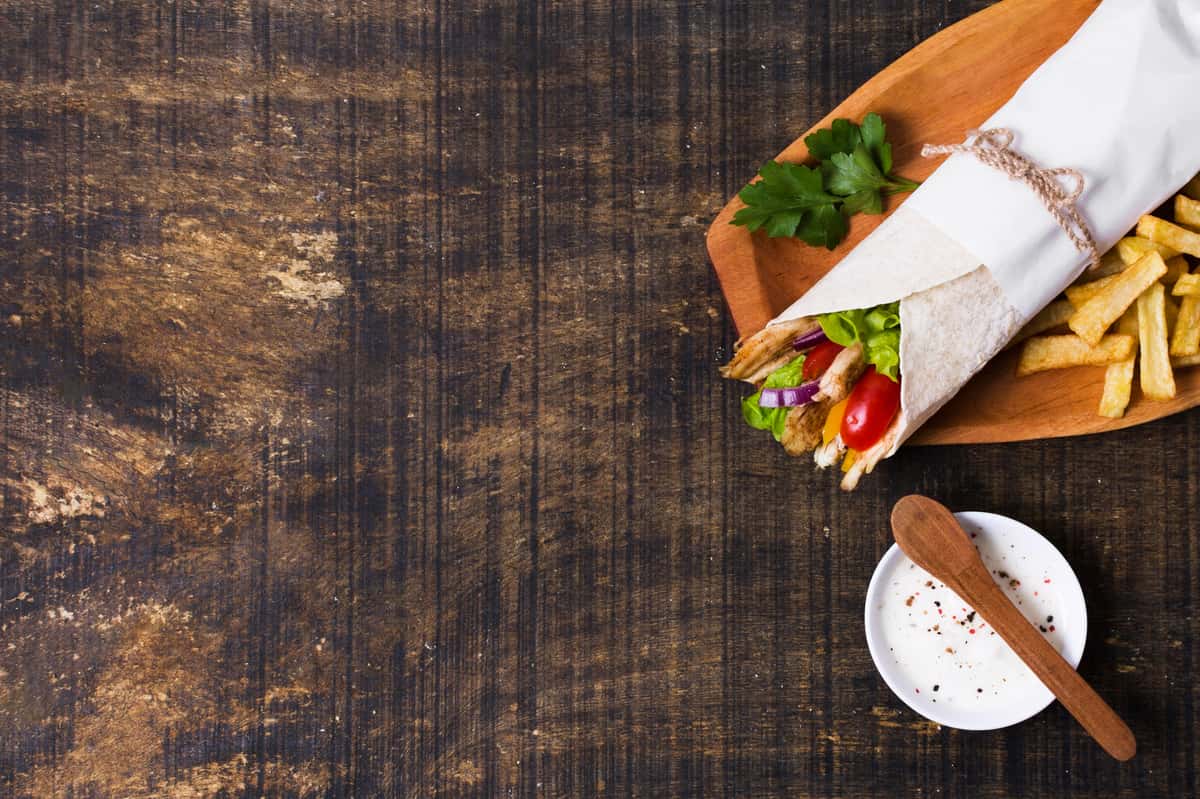 Arabic kebab sandwich wooden flat lay