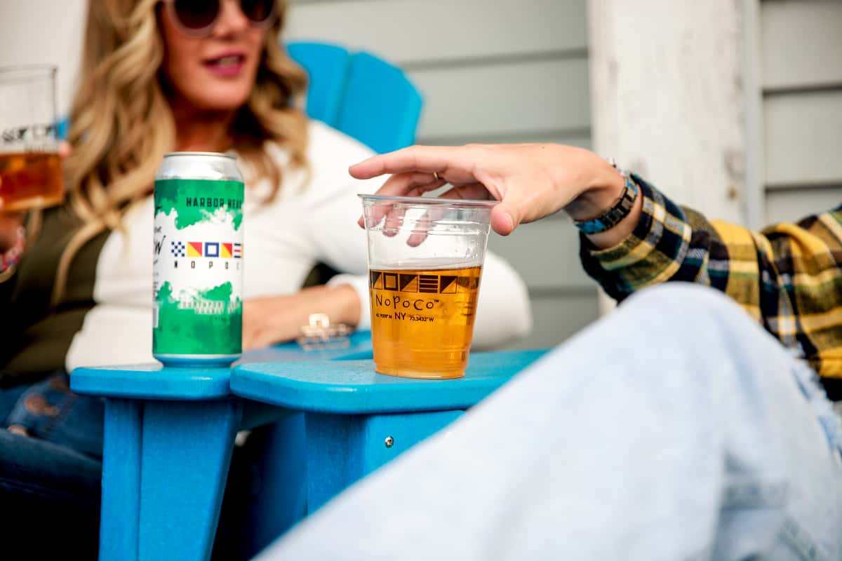 women sitting outdoors with beer