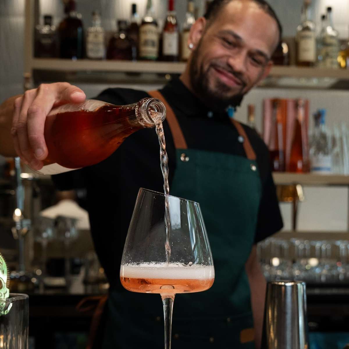 Man pouring drink in a glass