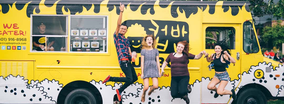 Group jumping in front of the Cupbop Food truck