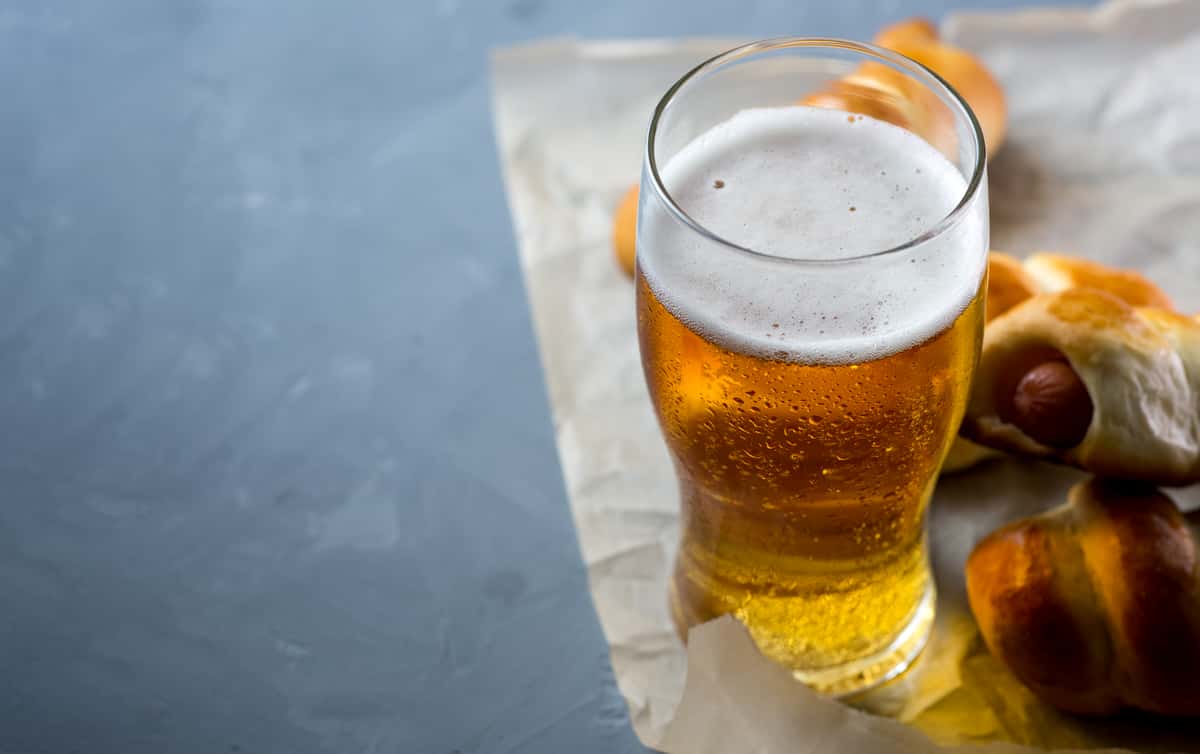 Pint glass of light lager beer on a table