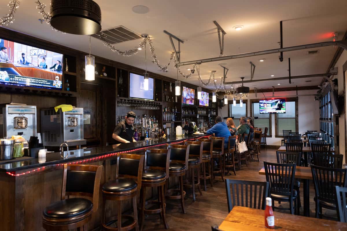 Bar area with bartender and guests
