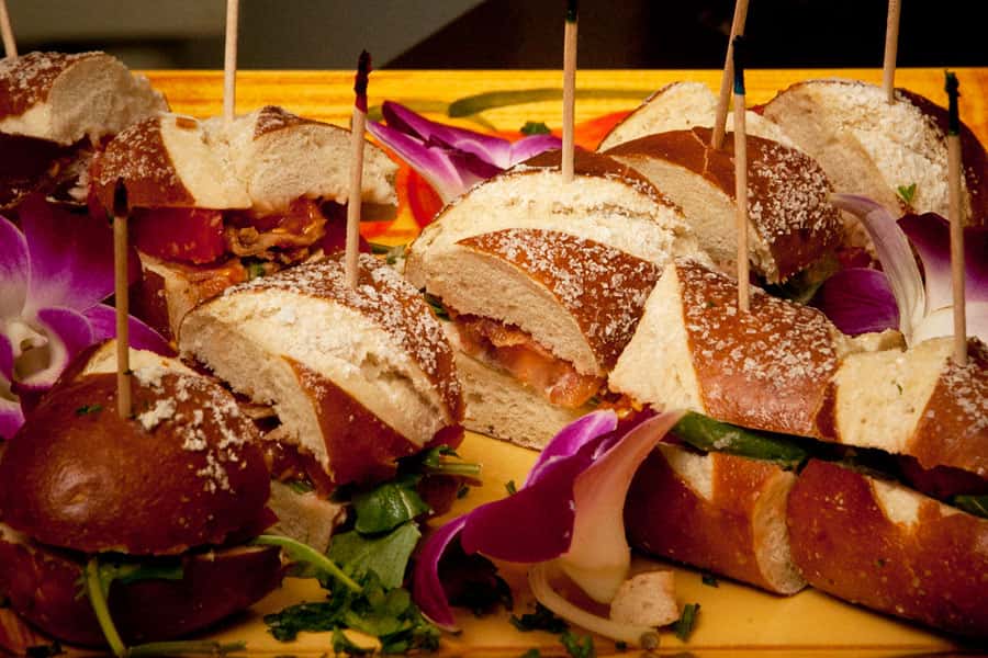 sandwiches on pretzel bread served on a platter