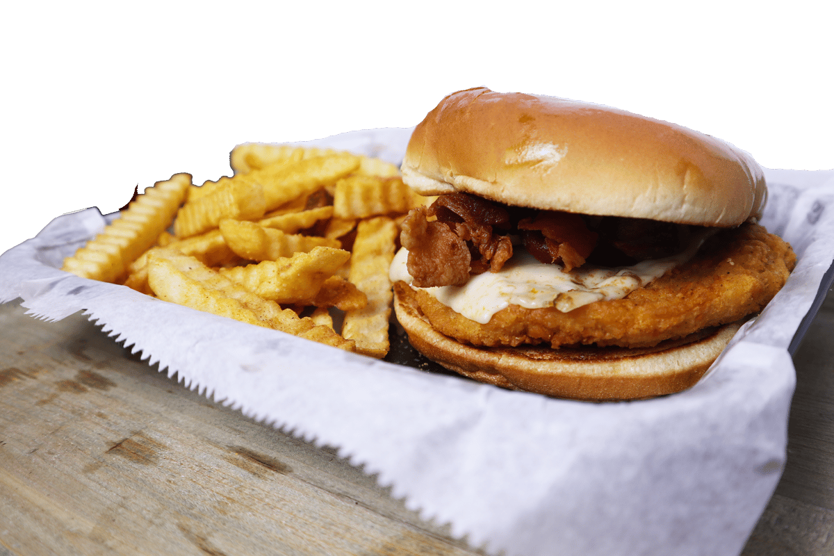 Hangry's Grill's juicy hamburger with melted cheese sits beside a pile of golden french fries.