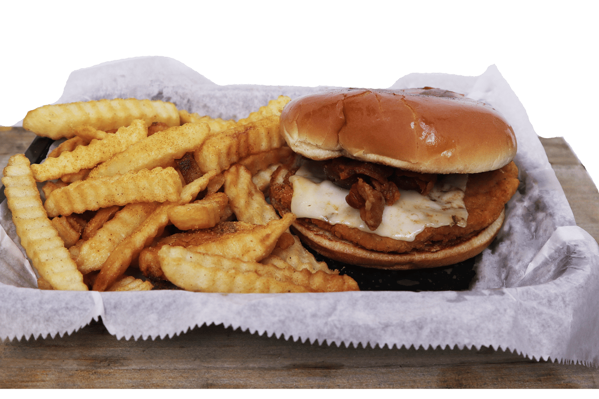 Hangry's Grill's crispy chicken sandwich with bacon and cheese sits beside a basket of crinkle-cut fries.