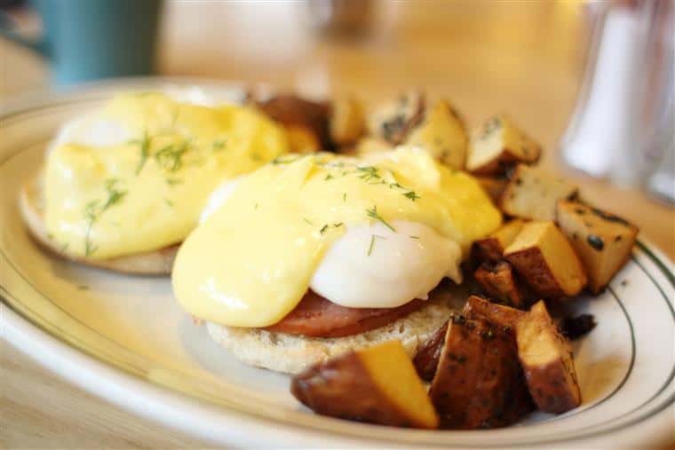 Eggs benedict with seasoned breakfast potatoes