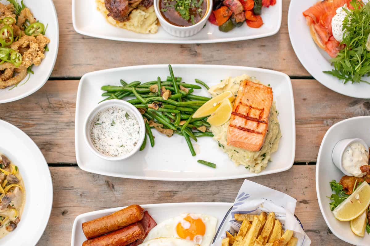 salmon with veggies and dip and more dishes