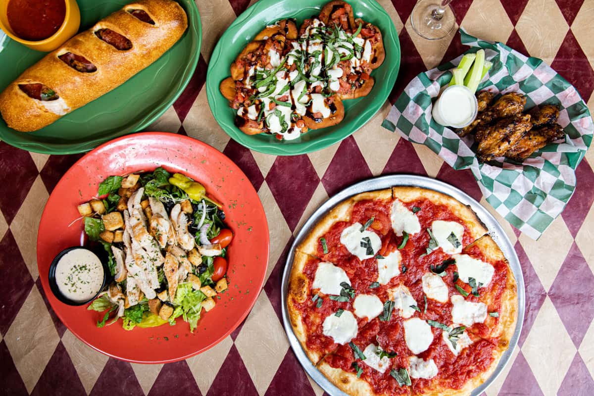 overhead view of pizza and sides