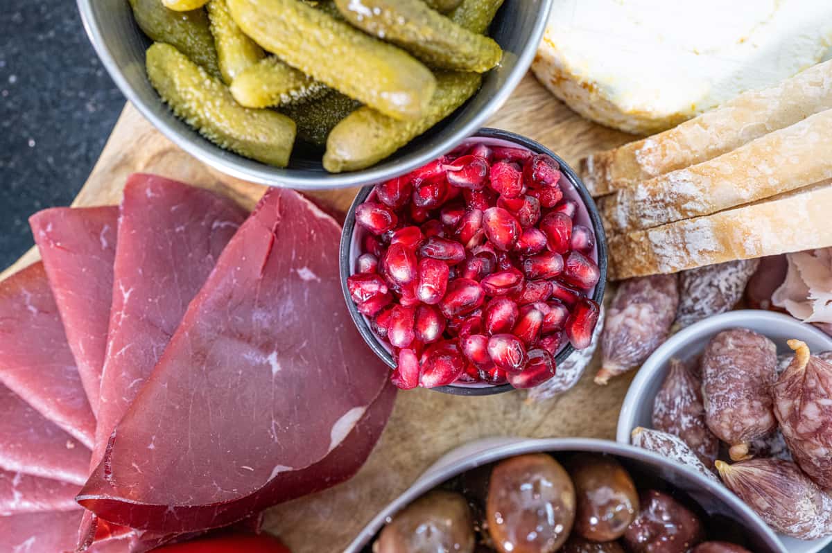Top view of a gourmet charcuterie board featuring cured meat.