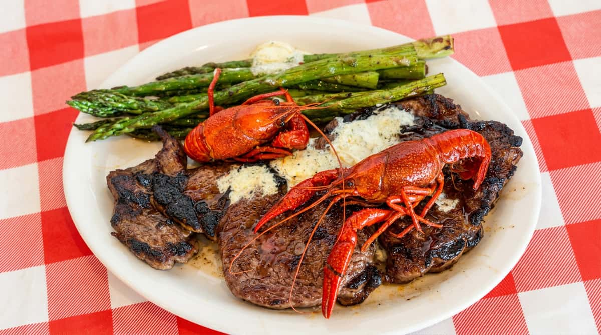 Steak with crawfish and grilled asparagus at Woody's Burgers and Bugs