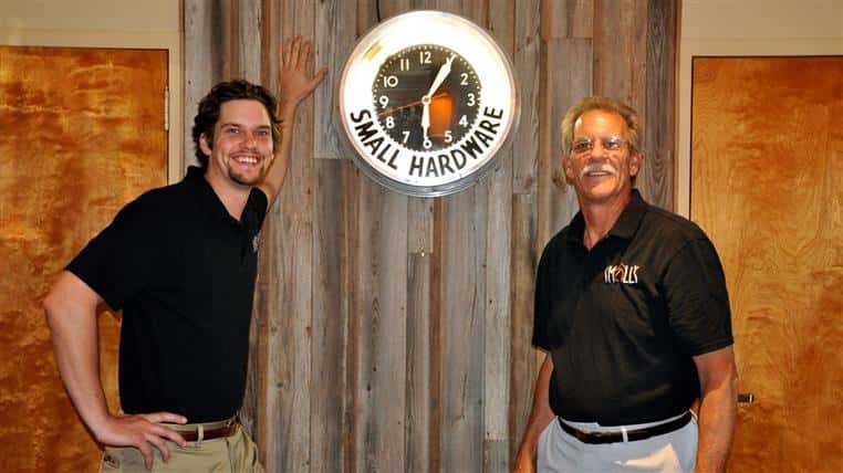 Father and Son in front of antique clock, in old NFK location