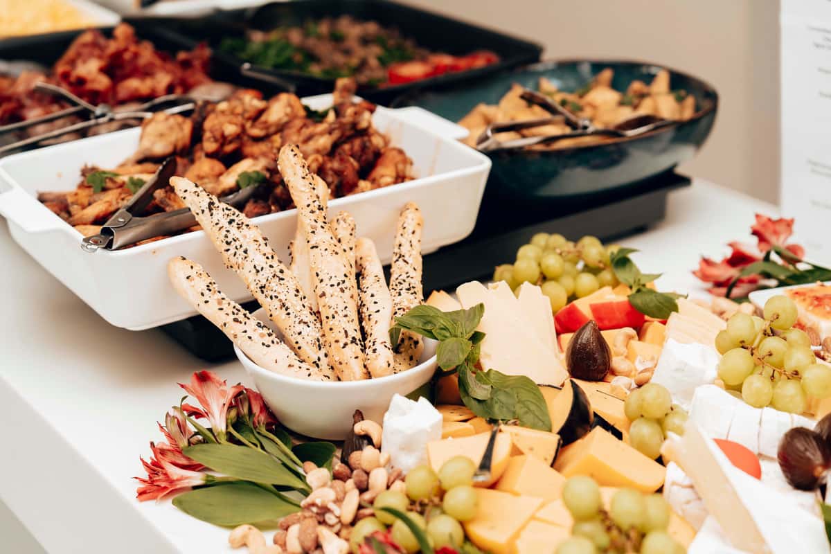 mouth-watering-assortment-of-cheeses-breadsticks-and-fruit