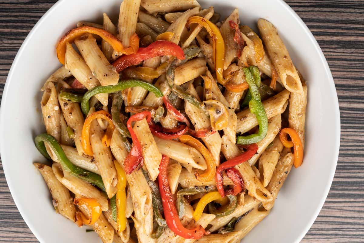 Penne noodles, tossed with sautéed green, red, and yellow peppers, in a mild creamy cheese sauce