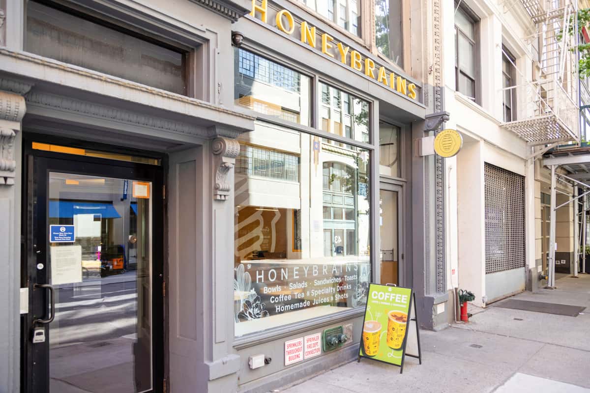 Street-level view of the café storefront featuring modern signage and a welcoming neighborhood dining destination.