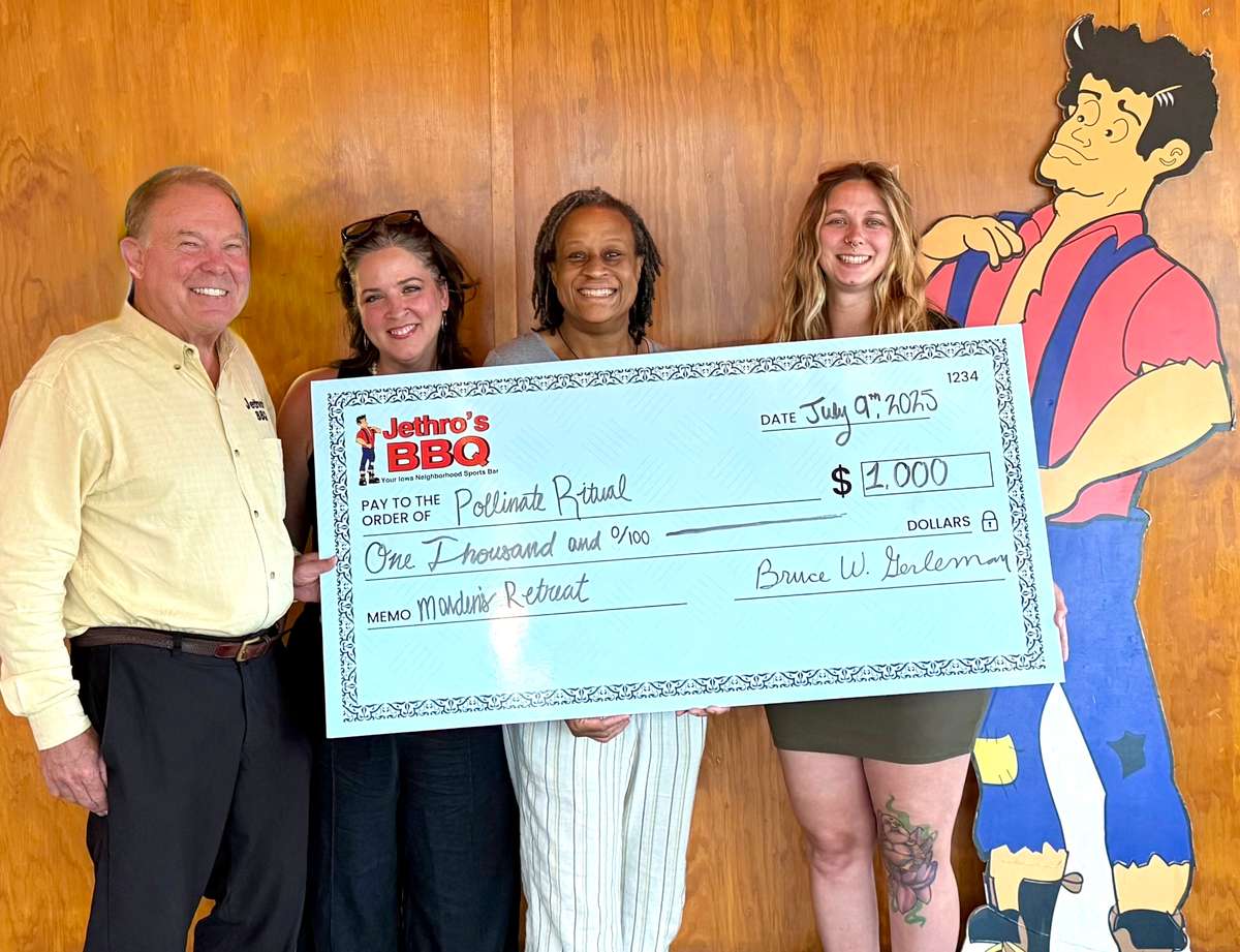 bruce presents check to pollinate ritual