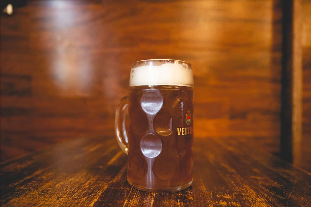 Traditional German beer served in a classic dimpled stein with a thick foamy head at Berliner Pub, offering an authentic pub experience for beer lovers.