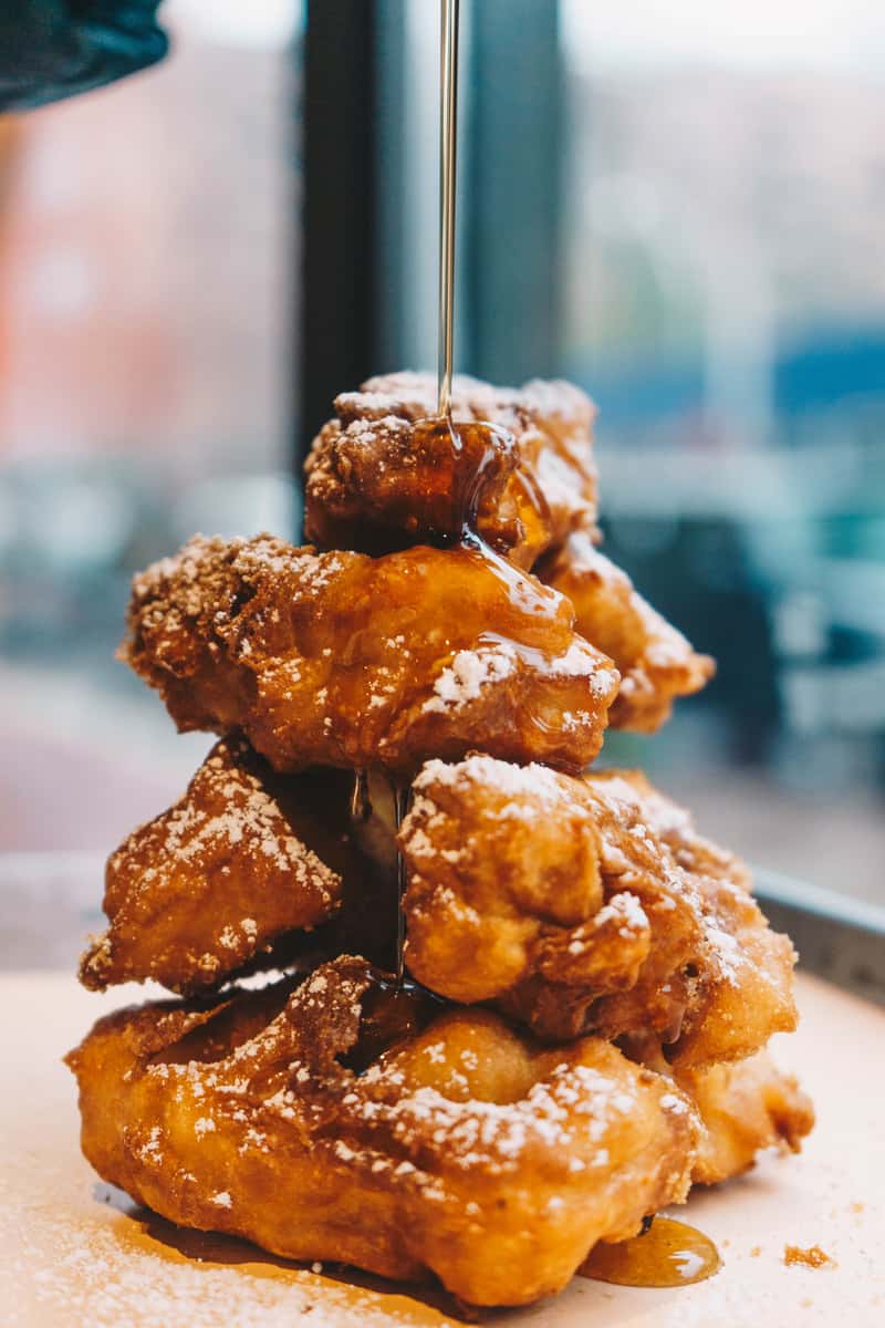 Syrup pouring onto chicken and waffles