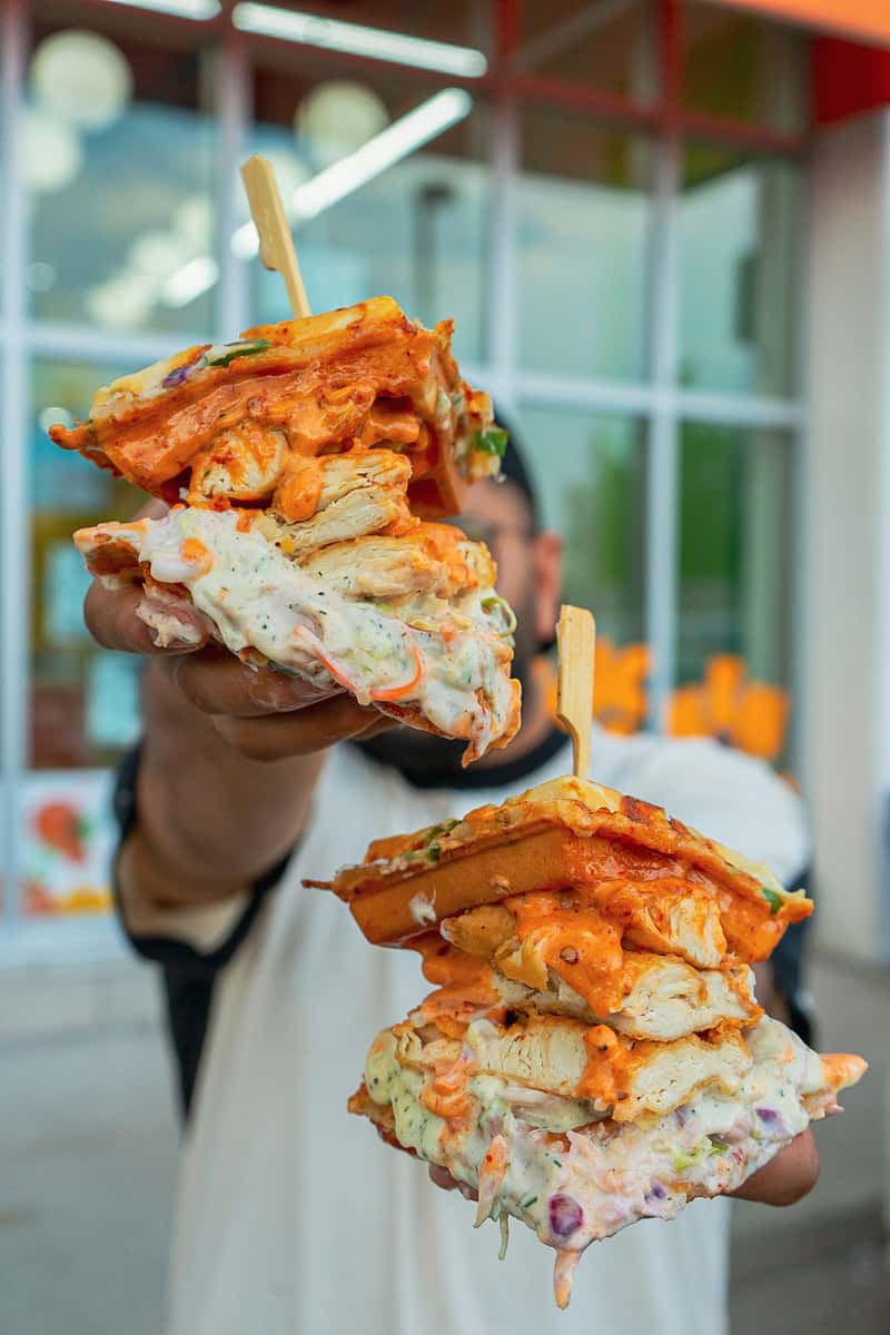 Person holding sandwiches