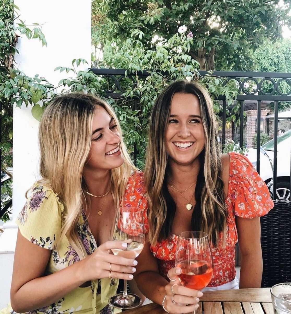 two ladies enjoying wine outdoors