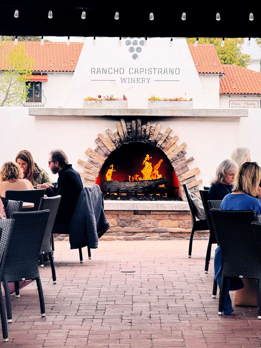 Outdoor patio dining area with a fireplace