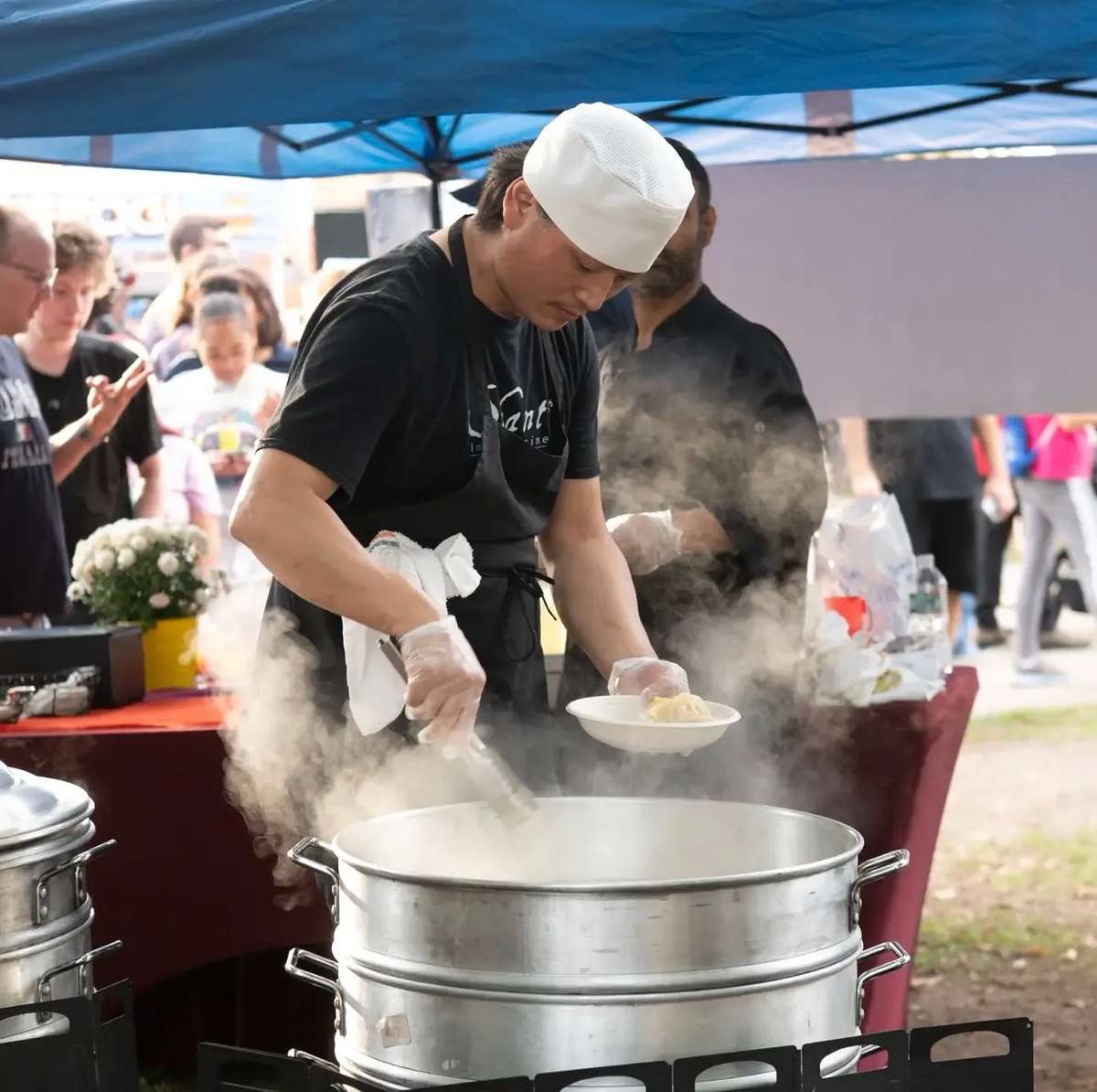 Shanti Restaurant chef preparing fresh momo dumplings at RVMS Dumpling Fest in Roslindale