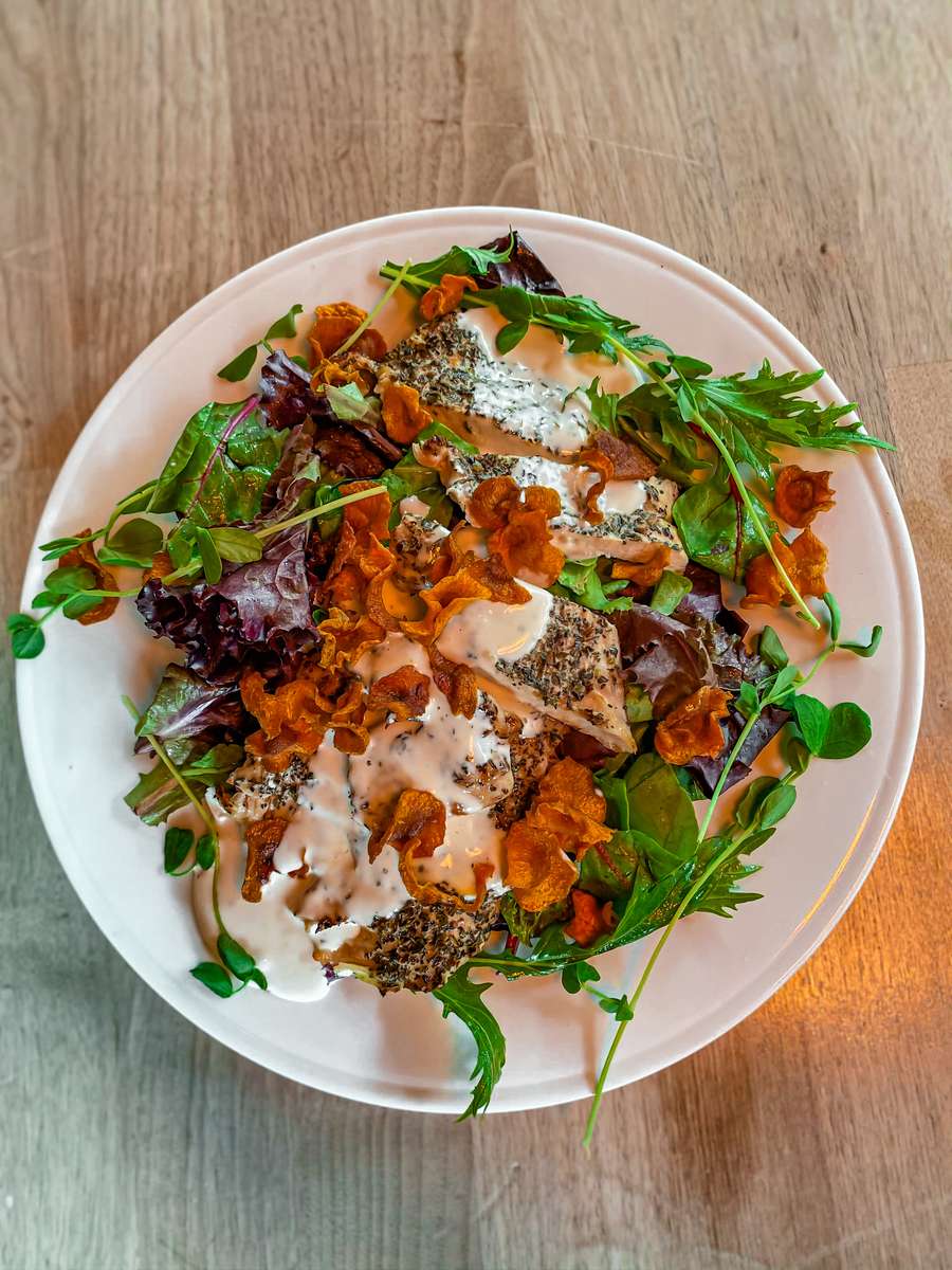 A seasonal salad with greens and roasted ingredients at The Marshal