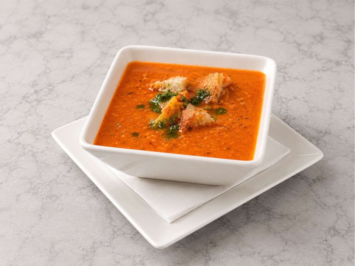 Chef-crafted tomato soup topped with seasoned croutons and fresh herbs at Local on North, featuring seasonal Southern-inspired cuisine in Canton and Marietta.