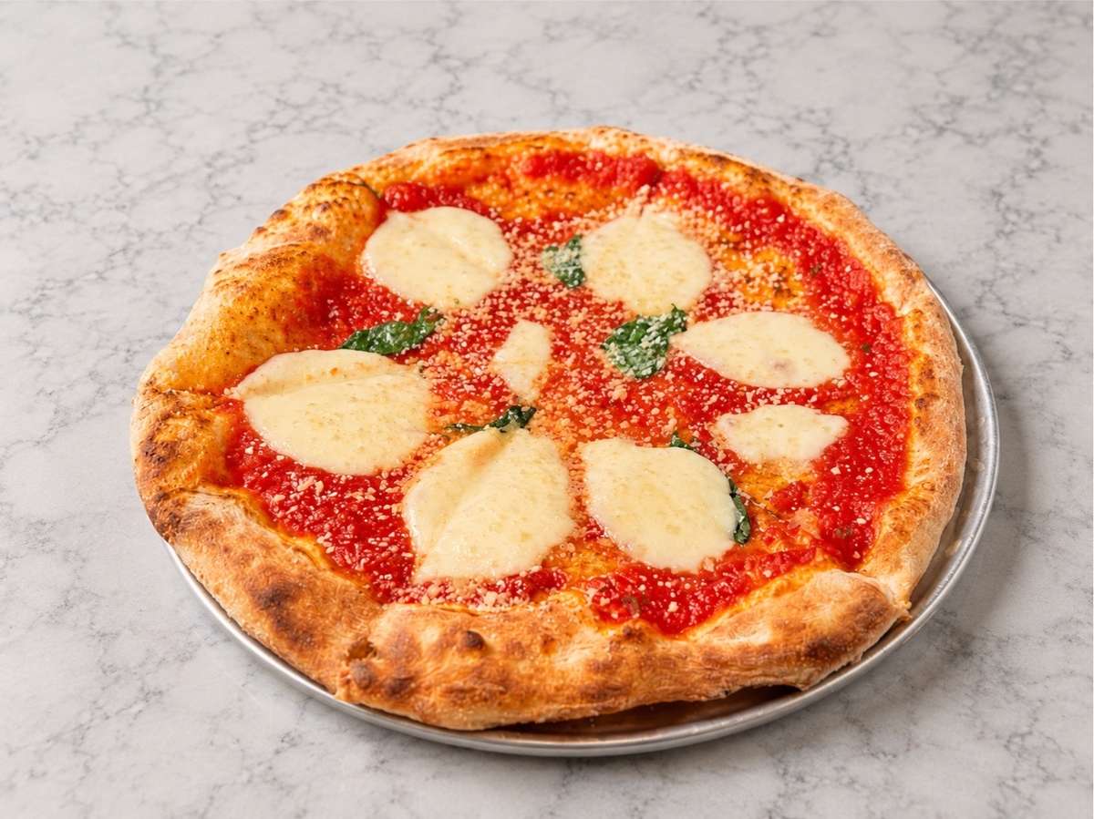 Wood-fired Margherita pizza with fresh mozzarella, house-made tomato sauce, and basil on a crisp artisan crust at Local on North, serving elevated Southern-inspired dining in Canton and Marietta.