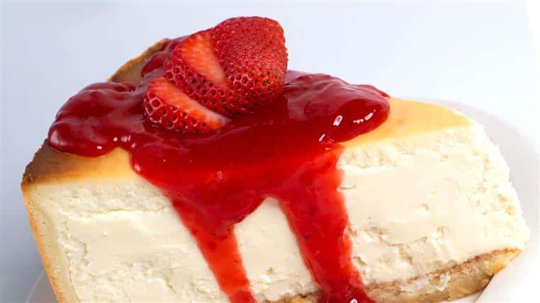 Slice of cheesecake topped with strawberries