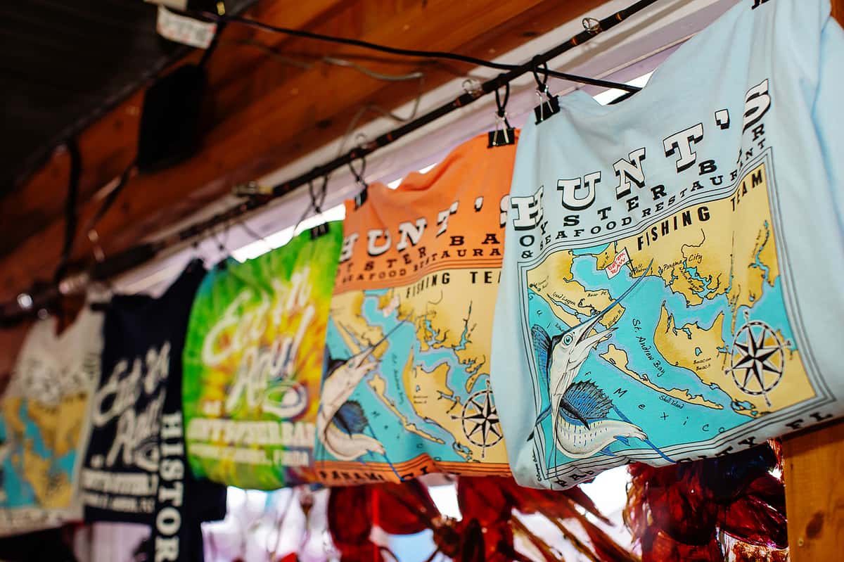 printed tshirts hanging from fishing pole