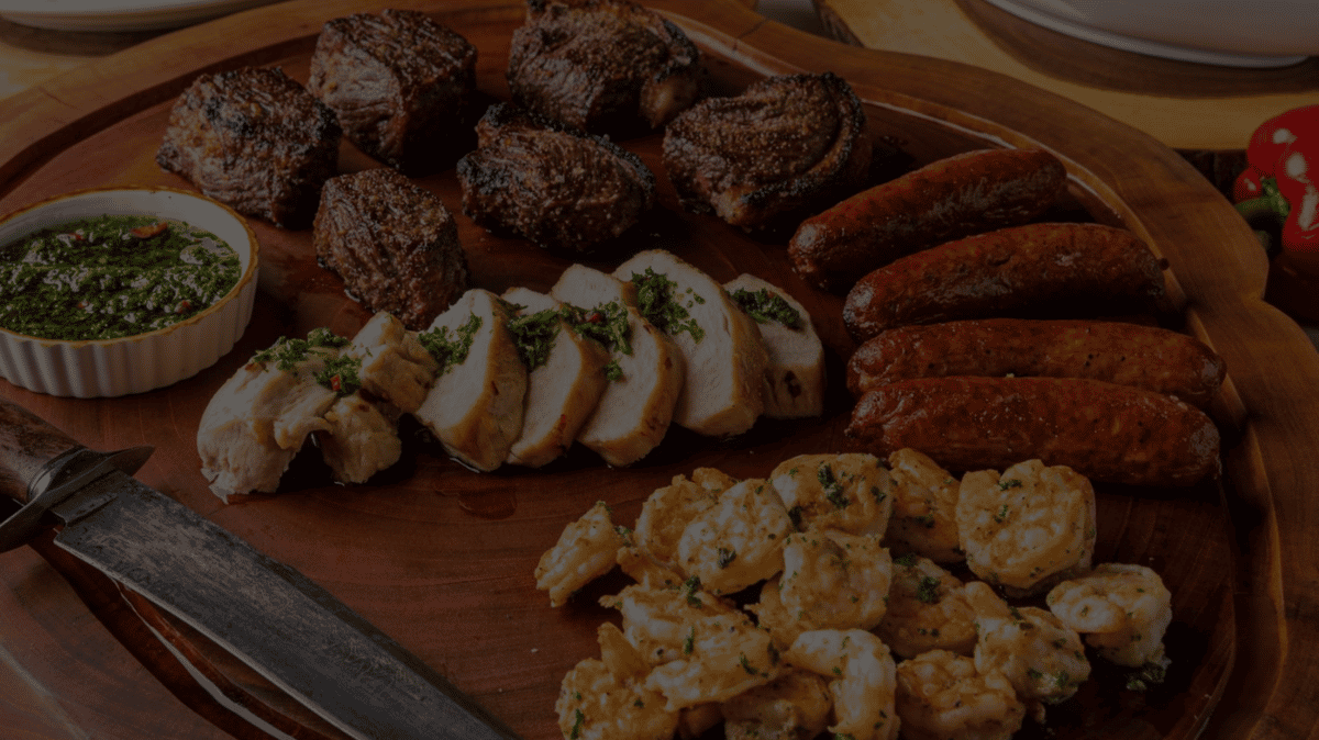 Different meats arranged on a wooden platter