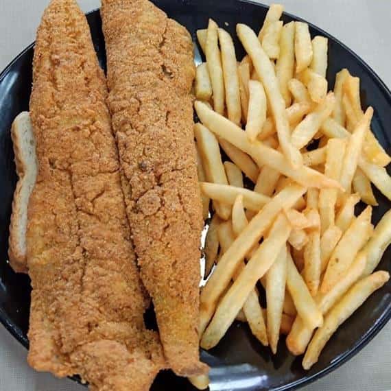 fried fish fillets served with fries and white bread