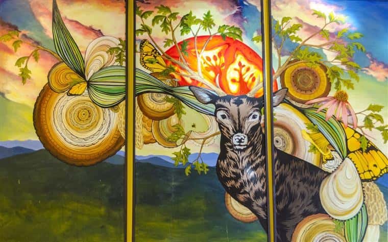 Artwork on wall of deer and nature