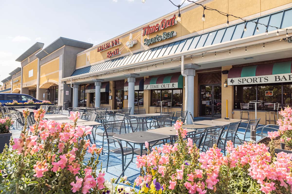 Restaurant exterior with flowers and outdoor seating