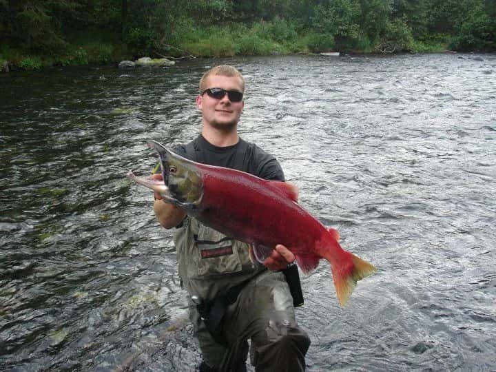 man holding coho salmon