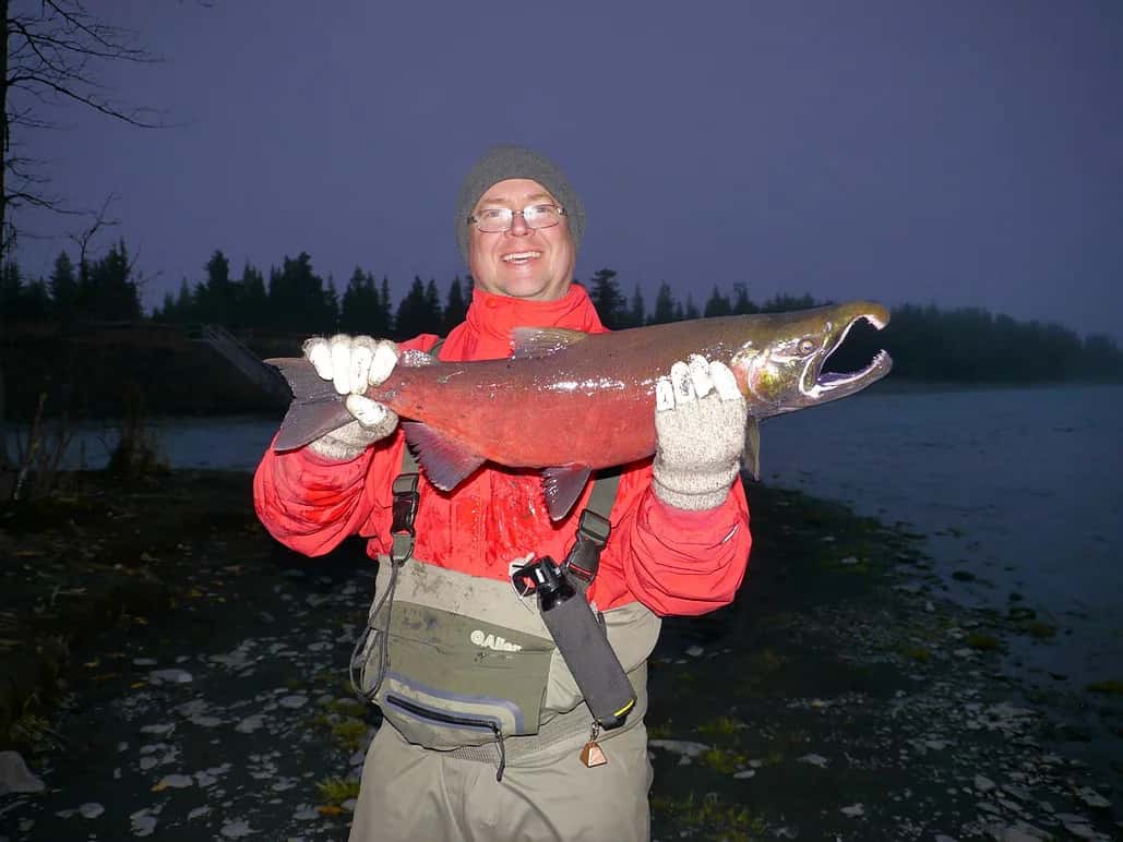 man holding coho salmon
