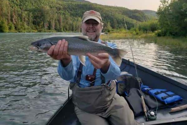 Keith of Gwin's Lodge, Cooper Landing Alaska With his catch a great Dolly Varden on the Kenai River after limiting on salmon fishing with his fishing guide in cooper landing Alaska