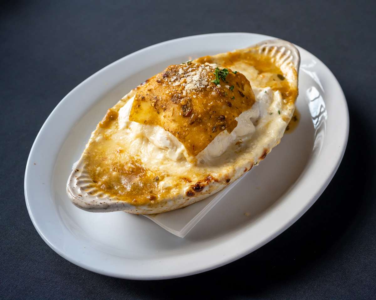Cheesy Southwestern Lasagna presented in a deep bowl with seasoning on top