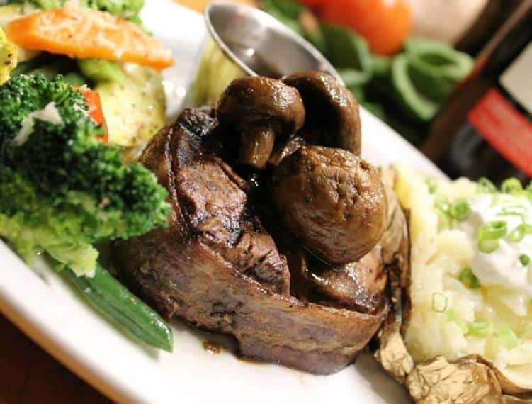 Steak dish served with sauteed vegetables