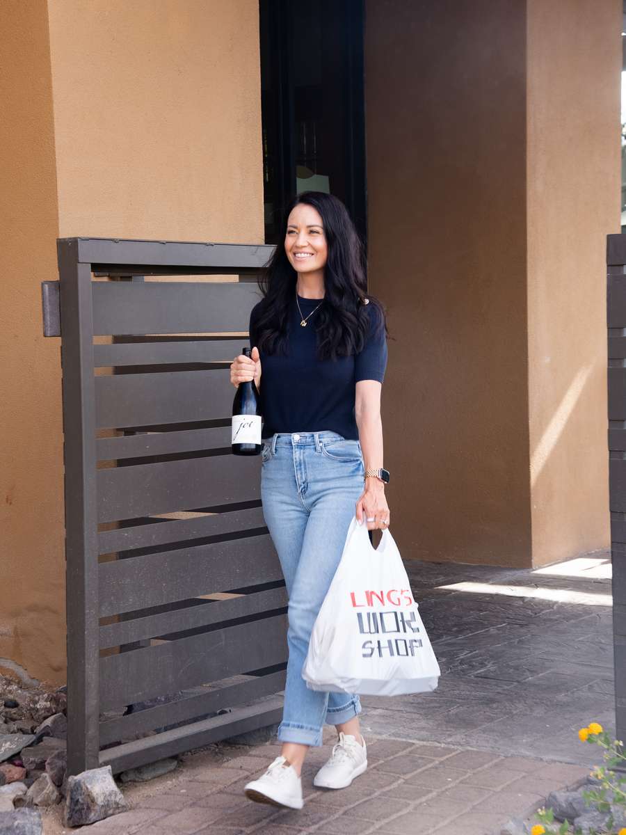 Woman with take out and bottle of wine